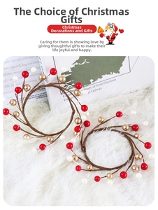 Detail showing red, pearl white, and gold berries on a rustic branch candle ring