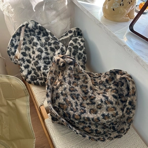 Close-up of large leopard print plush shoulder bags in grey and brown faux fur