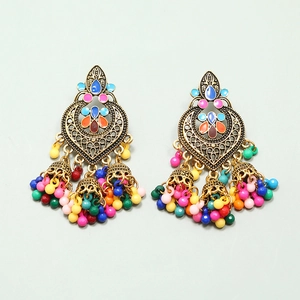 Detailed close-up of bohemian tassel earrings with gold filigree and colorful beads