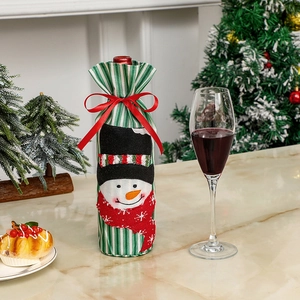Detail of Christmas wine bottle cover with snowman embroidery and festive ribbon bow