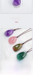 Close-up of polished teardrop crystal pendants including amethyst and rose quartz stones