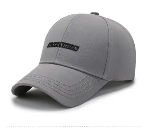 Detailed close-up of grey baseball cap showing embroidered YSFASHION patch and peak stitching