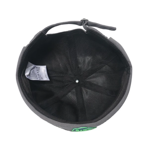 Detail view of cotton docker cap interior with adjustable strap and care label