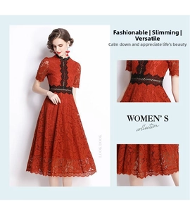 Detail of red lace dress with high neck and black floral embroidery on the waist