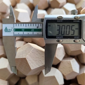 Handcrafted wooden Date Night Dice with 30mm diameter shown being measured by digital calipers
