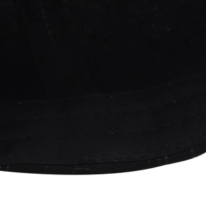 Close-up detail of reinforced parallel stitching on high-quality black twill baseball cap brim