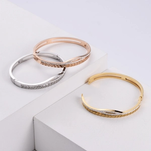 Macro detail of stacking bracelets with meander patterns and pavé-set zircon crystals