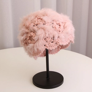 Detailed view of pink handmade crochet knit beanie with rabbit fur floral pattern