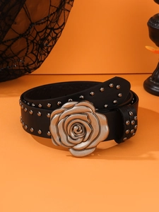 Close-up of black punk belt featuring silver metal rose buckle and studded rivets