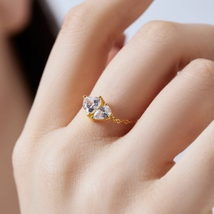 Close-up of adjustable gold chain ring with two teardrop-shaped white zircon stones