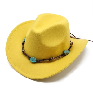 Detail of yellow felt cowboy hat featuring turquoise gemstone beads and ethnic band