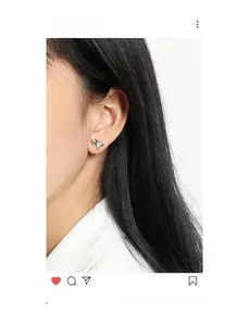 Close-up of minimalist S925 silver lava droplet earring with a polished mirror finish