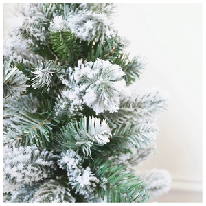 Detailed close-up showing the dense needles and realistic white flocking on a mini Christmas tree
