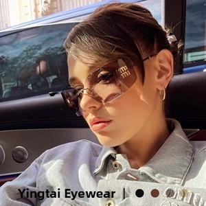 Close-up of rimless flame-shaped sunglasses with gradient brown lenses and metal frame