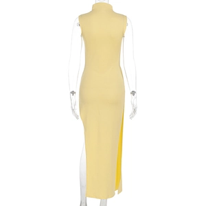 Detail view of bright yellow sleeveless dress with high slit and elegant side drape fabric