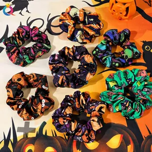 Set of seven Halloween scrunchies featuring pumpkin and skull prints on satin fabric