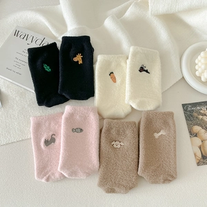 Flat lay of warm coral fleece crew socks with cute cartoon embroidery in four colors