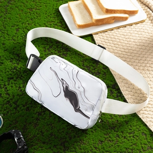 Waterproof marble pattern waist bag with adjustable white strap on a green moss background