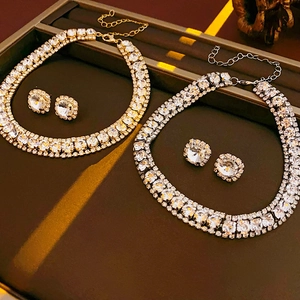 Exquisite close-up of gold and silver square rhinestone necklace and earring sets