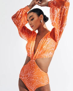 Detail of long sleeve orange swimsuit with coral print and stylish side cut-outs