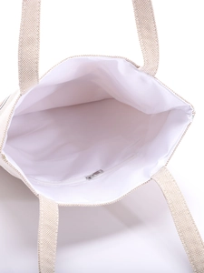 Internal view of beige canvas tote bag featuring a practical metal zipper pocket