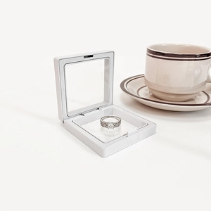 White square PE film floating jewelry box with ring for dustproof display on white background