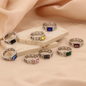 Retro multi-color zircon titanium steel rings with 18K gold plating on stone display