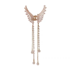 Elegant butterfly hair claw clip with pearl tassels and gold metal frame on white backdrop