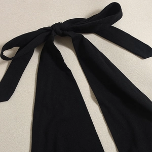 Detail shot of the backless tie neck lace-up on this sexy black dress fabric texture