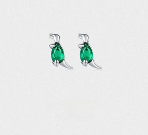 Detailed view of silver dinosaur stud earrings featuring sparkling green zircon gemstones
