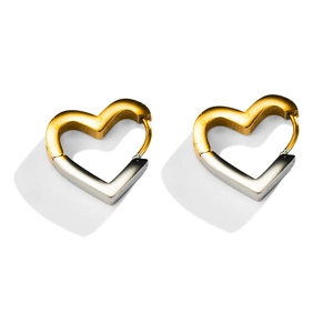 Macro shot of two-tone gold and silver heart-shaped stainless steel earrings with buckle