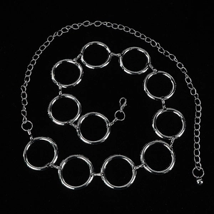 Silver metal chain belt with large interlocking rings for women over a black background