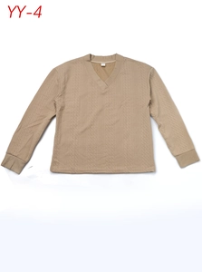 Detail of beige V-neck knitted sweater featuring ribbed cuffs and waffle weave texture