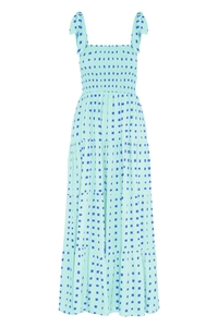 Detail of mint green tiered summer dress featuring blue polka dots and ruffle texture