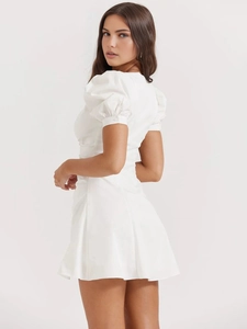 White French style V-neck mini dress with puff sleeves shown from a side rear view