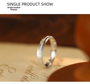 Macro view of S925 silver ring featuring delicate spiral texture and a brushed finish