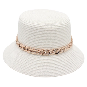 White straw bucket hat with chunky gold chain decoration on a clean white background