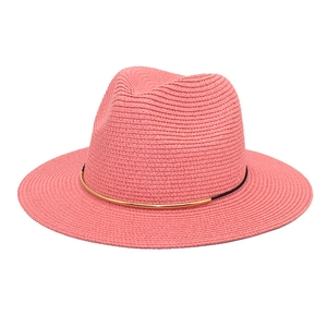 Close-up of pink straw fedora hat featuring black band and gold metal tube detail