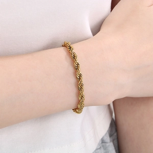 Detail of 18K gold plated rope chain bracelet with lobster clasp on a woman's wrist