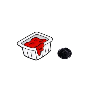 Cute enamel pin shaped like a small ketchup sauce container with a red wavy texture