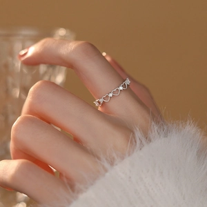 Elegant S925 sterling silver hollow heart ring with diamonds worn by a model