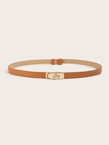 Detail of slim brown leather belt with gold twist lock buckle and cross pattern texture