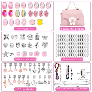 Detailed view of DIY jewelry kit with pink gift bag, beads, charms and bracelets