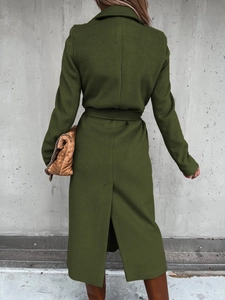 Rear view of an olive green wool coat with slim fit cut and matching waist belt detail