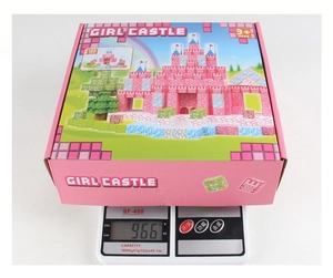 Pink castle magnetic block set 128pcs packaging being weighed on a digital scale