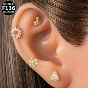 Detailed close-up of sterile G23 titanium labrets with snowflake and flower shapes