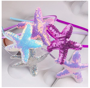 Detail of colorful sequined starfish headbands in pink, purple, blue and silver glitter