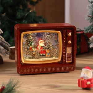 Close-up of retro Christmas TV snow globe with Santa Claus and sparkling glitter