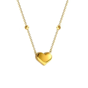 Minimalist gold heart necklace with beaded chain on a professional white background