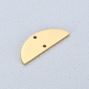 Macro view of polished gold stainless steel semicircular pendant with dual connector holes